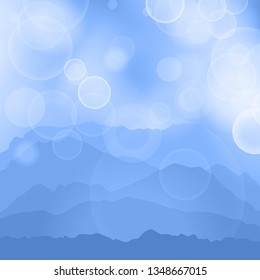 blue calm majestic mountain landscape with fog, mist and glare in sky