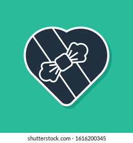 Blue Candy in heart shaped box and bow icon isolated on green background. Valentines Day.  Vector Illustration