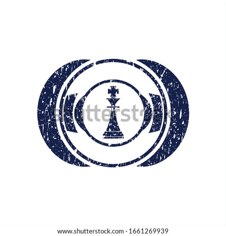 Blue chess king icon inside rubber grunge stamp