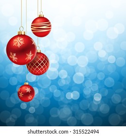 A Blue Christmas background, with 4 red decorated christmas balls hanging from above.