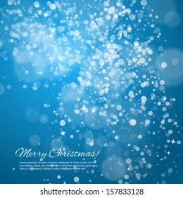 Blue Christmas background with bokeh and stars