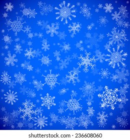 Blue Christmas background with different snowflakes falling