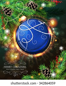 Blue Christmas ball among pine branches with pine cones and winter berries on a sparkling  holiday background
