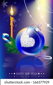 Blue Christmas ball, candle, candy and a Christmas tree branch on a blue background