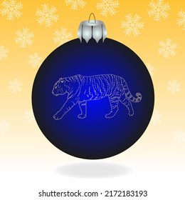 A blue Christmas ball with a tiger in the background with snowflakes.