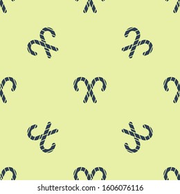 Blue Christmas candy cane with stripes icon isolated seamless pattern on yellow background. Merry Christmas and Happy New Year.  Vector Illustration