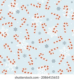 Blue Christmas seamless pattern with red candy cane and snowflakes