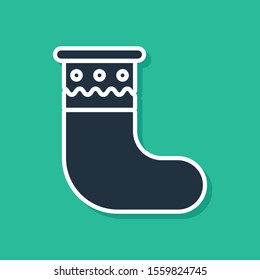 Blue Christmas stocking icon isolated on green background. Merry Christmas and Happy New Year.  Vector Illustration