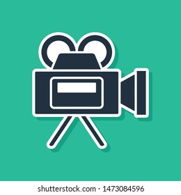 Blue Cinema camera icon isolated on green background. Video camera. Movie sign. Film projector.  Vector Illustration