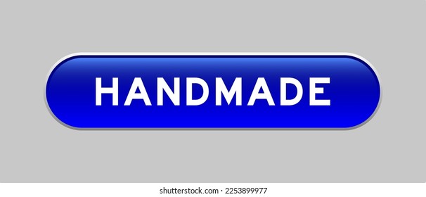 Blue color capsule shape button with word handmade on gray background