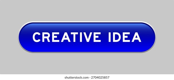 Botón azul de la forma de la cápsula del color con la idea creativa de la palabra en fondo gris