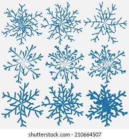 Blue colored winter snowflakes collection hand drawn with brushes. Vector illustration.
