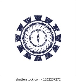 Blue compass icon inside distressed grunge seal