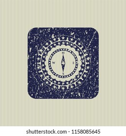 Blue compass icon inside rubber grunge texture stamp