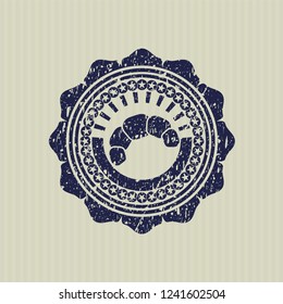 Blue croissant icon inside distressed rubber texture