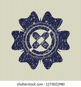 Blue crossed bandage plaster icon inside distressed rubber seal