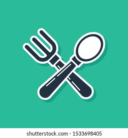 Blue Crossed fork and spoon icon isolated on green background. Cooking utensil. Cutlery sign.  Vector Illustration