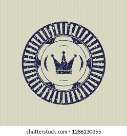 Blue crown icon inside distressed rubber stamp with grunge texture