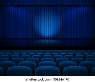 Blue curtain from the theatre with a spotlight and row chairs