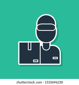 Blue Delivery man with cardboard boxes icon isolated on green background. Door to door delivery by courier.  Vector Illustration