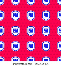Blue Delivery pack security with shield icon isolated seamless pattern on red background. Delivery insurance. Insured cardboard boxes beyond the shield.  Vector Illustration