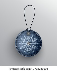 Blue denim round badge with cord and white snowflake with diamond.