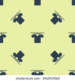 Blue Drying clothes icon isolated seamless pattern on yellow background. Clean shirt. Wash clothes on a rope with clothespins. Clothing care and tidiness.  Vector