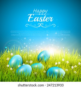 Blue Easter background with eggs in the grass and place for your text