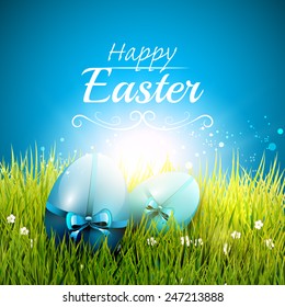 Blue Easter greeting card with Easter eggs in the grass
