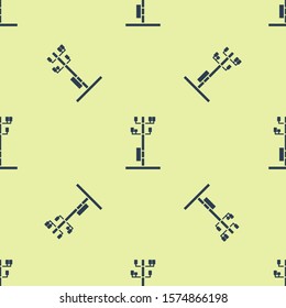 Blue Electric tower used to support an overhead power line icon isolated seamless pattern on yellow background. High voltage power pole line.  Vector Illustration