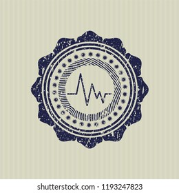Blue electrocardiogram icon inside rubber grunge seal