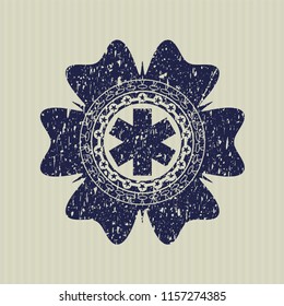 Blue emergency cross icon inside distressed rubber stamp with grunge texture