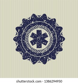 Blue emergency cross icon inside grunge stamp