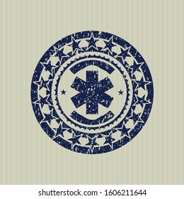 Blue emergency cross icon inside distress rubber grunge stamp