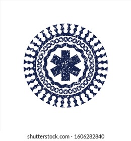 Blue emergency cross icon inside distressed rubber grunge texture seal