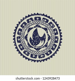 Blue fire icon inside distressed rubber stamp
