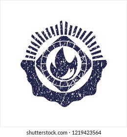 Blue fire icon inside rubber grunge seal