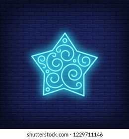 Blue frozen star neon sign. Glowing star with pattern on dark blue brick background. Can be used for home decorations, Christmas time, New Year
