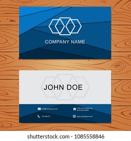 Blue geometric business card design template on wood background