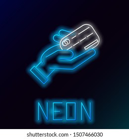 Blue glowing neon line Human hand holding with credit card icon isolated on black background. Online payment. Pay by card. Financial operations. Colorful outline concept. Vector Illustration Blue glowing neon line Human hand holding with credit card icon isolated on black background. Online payment. Pay by card. Financial operations. Colorful outline concept. Vector Illustration