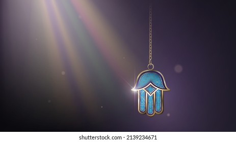 Blue and gold Hamsa (Hand of Fatima) on a chain in the rays of light, an oriental evil eye amulet