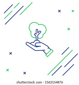 Blue and green line Tree in hand of environmental protection icon isolated on white background. Seed and seedling. Planting sapling. Ecology concept. Colorful outline concept. Vector Illustration