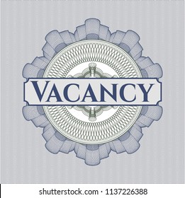 Blue and green money style rosette with text Vacancy inside