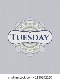 Blue and green passport rossete with text Tuesday inside