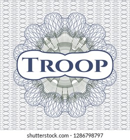 Blue and green passport style rosette with text Troop inside