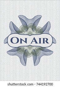 Blue and green rosette with text On Air inside