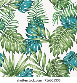 Blue and green tropical leaves seamless white background