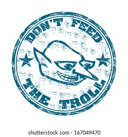 Blue grunge rubber stamp with a troll face and the text do not feed the troll written with capital letters