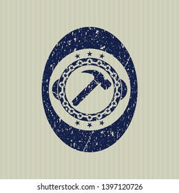 Blue hammer icon inside distress rubber stamp with grunge texture