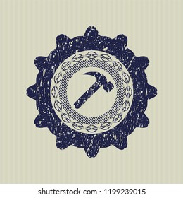 Blue hammer icon inside distressed rubber seal with grunge texture